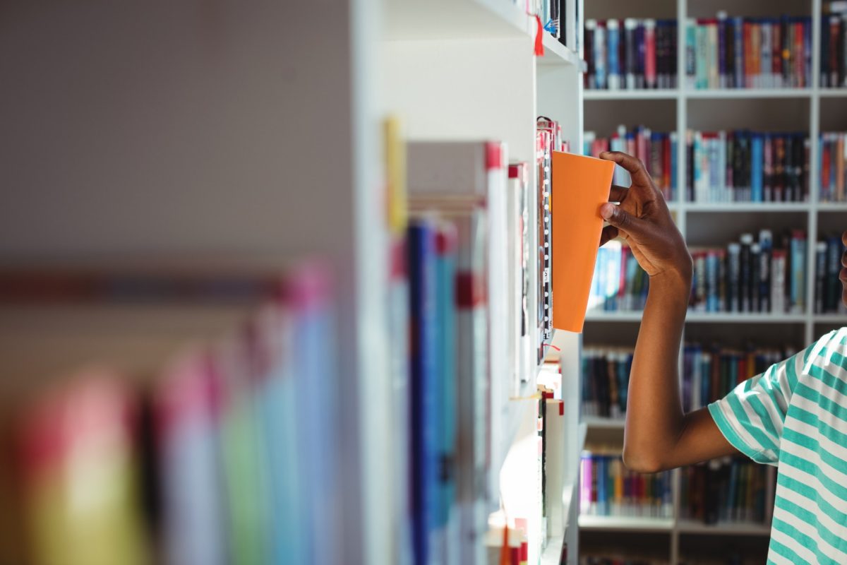 schoolboy-selecting-book-in-library.jpg