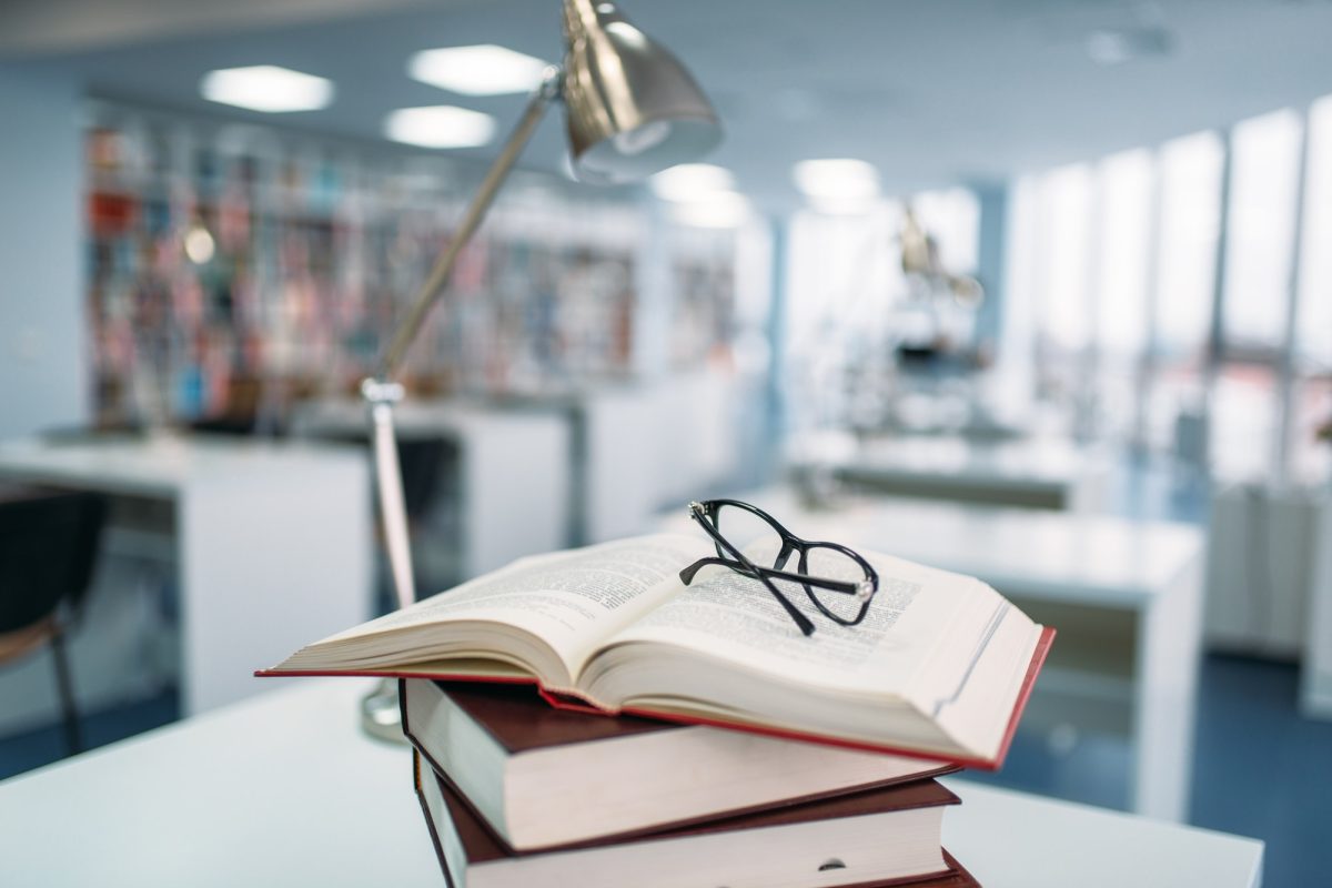 stack-of-books-and-glasses-on-table-in-library.jpg