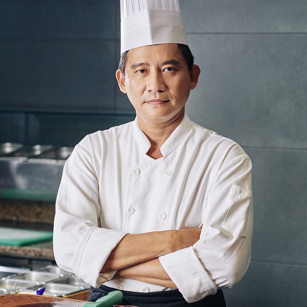 asian-mature-chef-in-the-kitchen-PXSH4U5.jpg